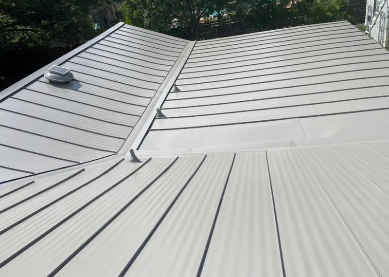 Solar attic fan installed on a metal roof for Roof Ventilation in Paris
